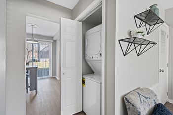 A small laundry room with a washer and dryer.